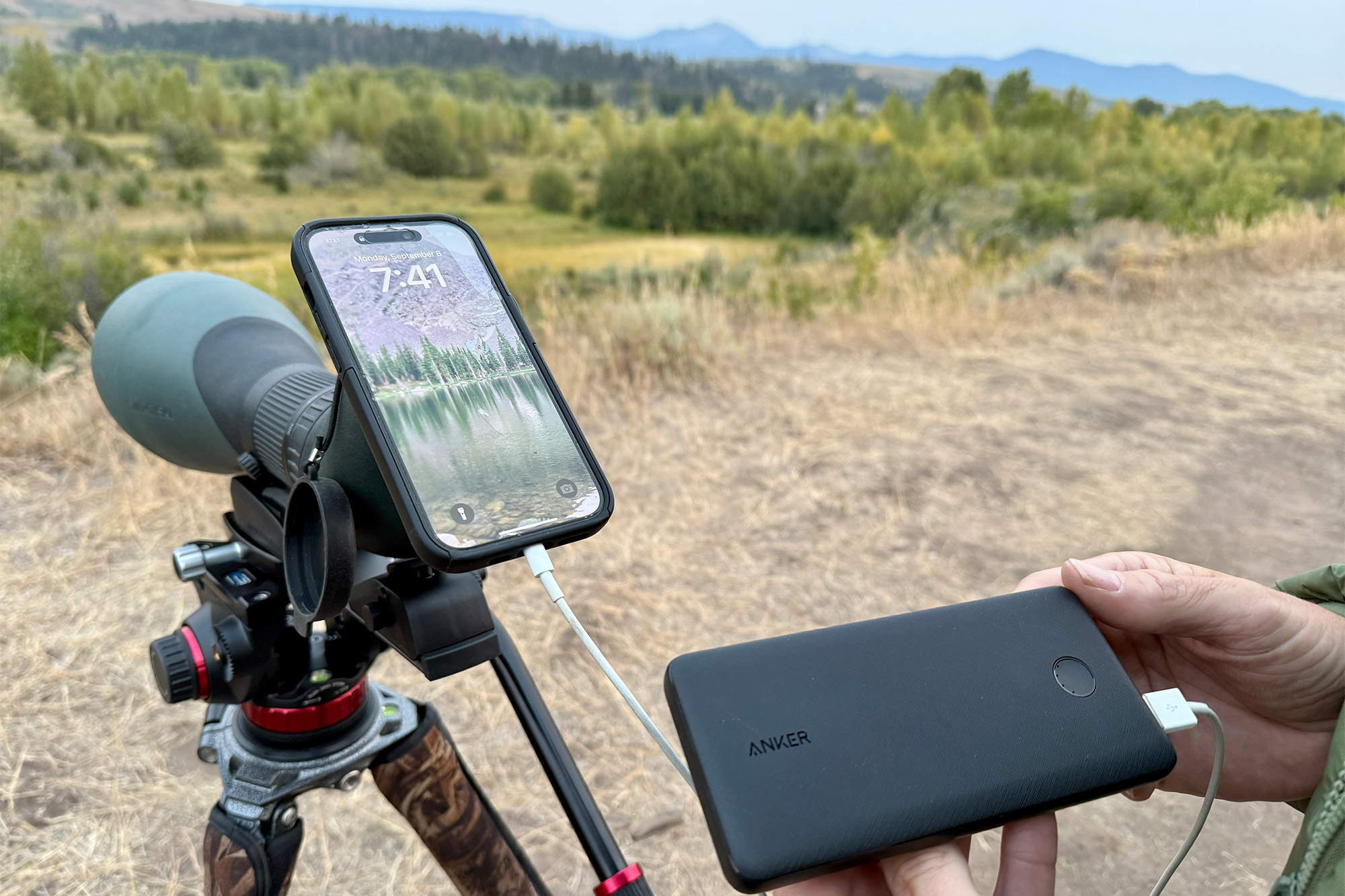 Anker 313 Power Bank powering a phone on a tripod in the field