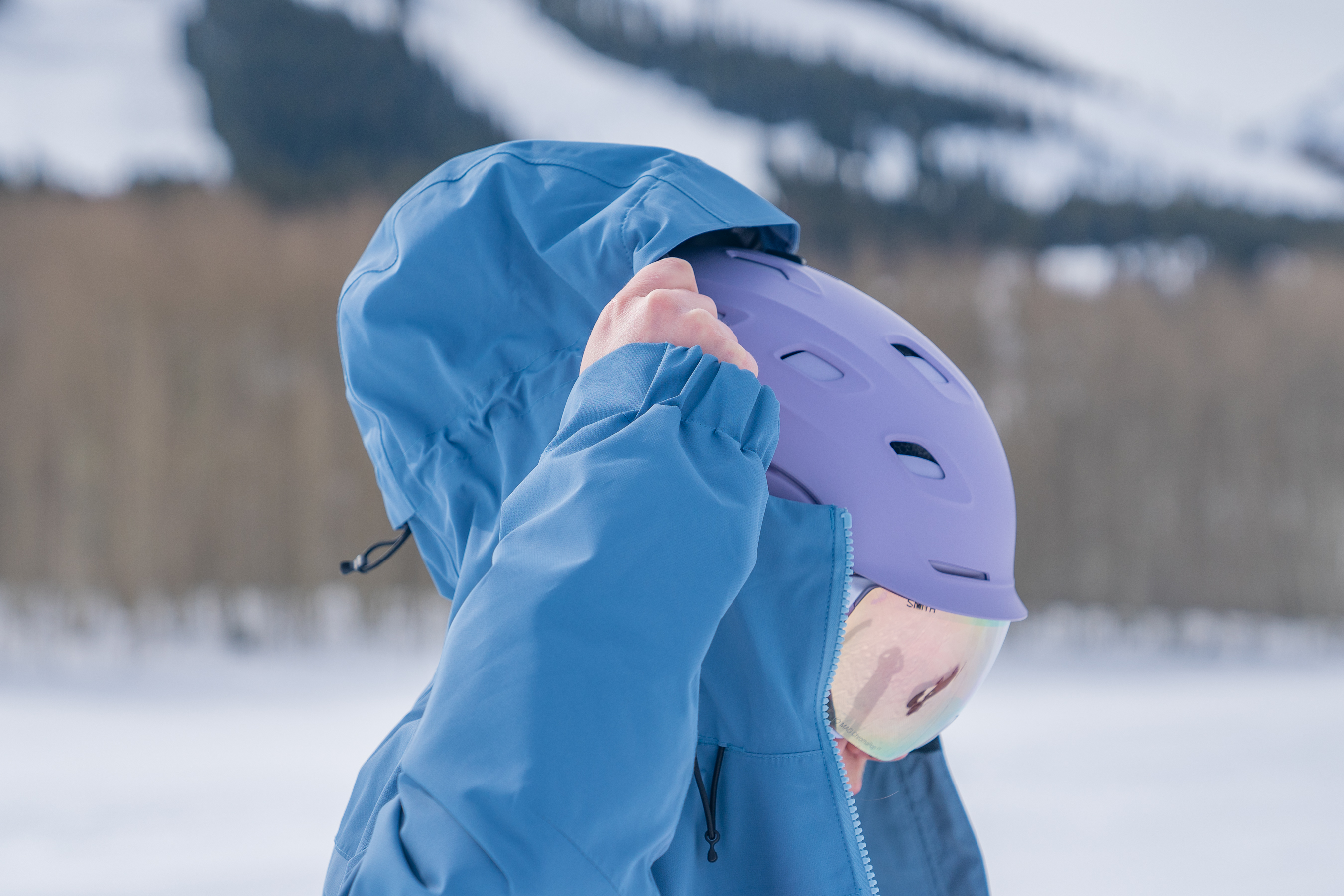 Snowboarder Pulls Hood Over Helmet Snowboarder Pulls Hood Over Helmet