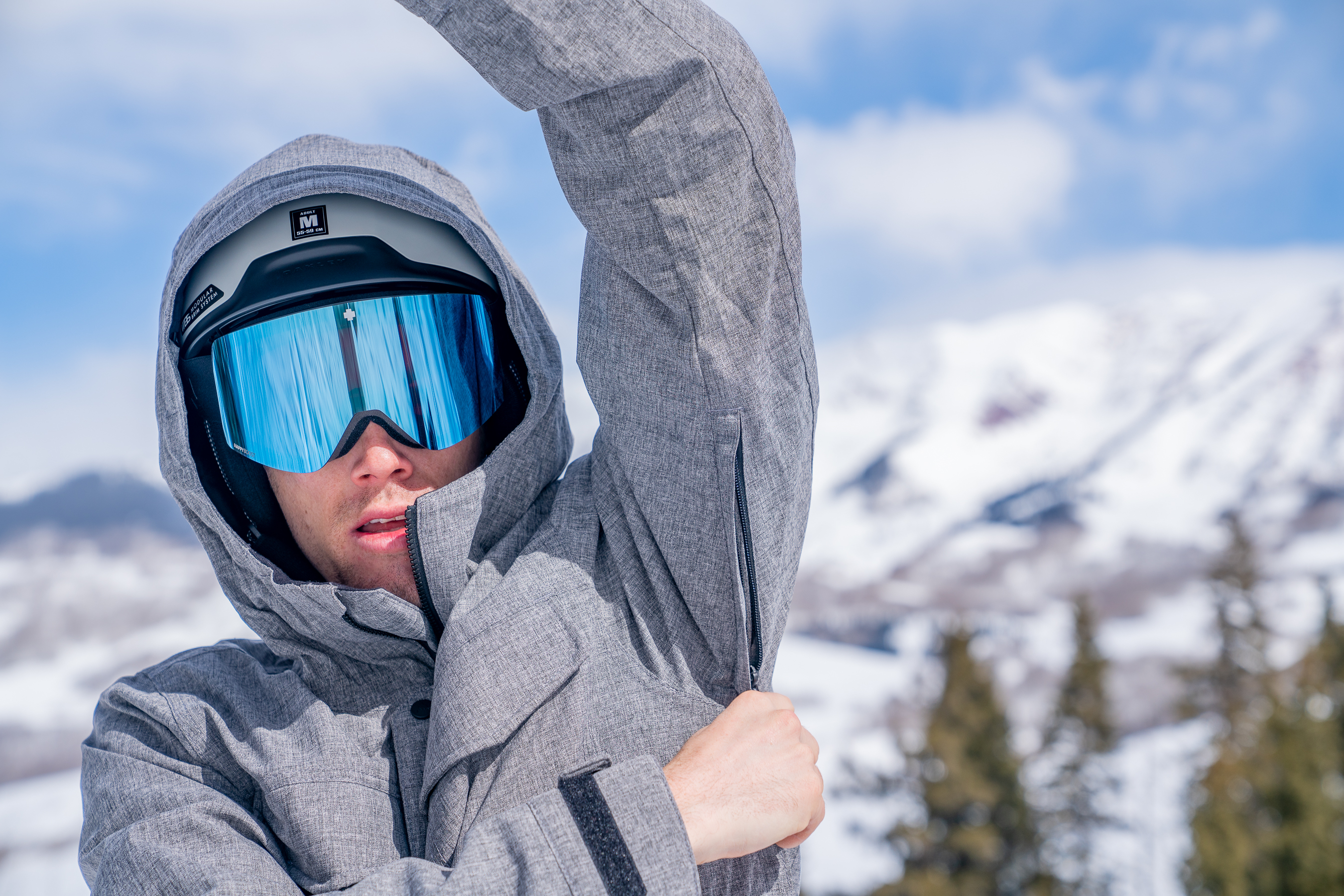 Snowboarder Pulls Down Underarm Vents on Jacket Snowboarder Pulls Down Underarm Vents on Jacket
