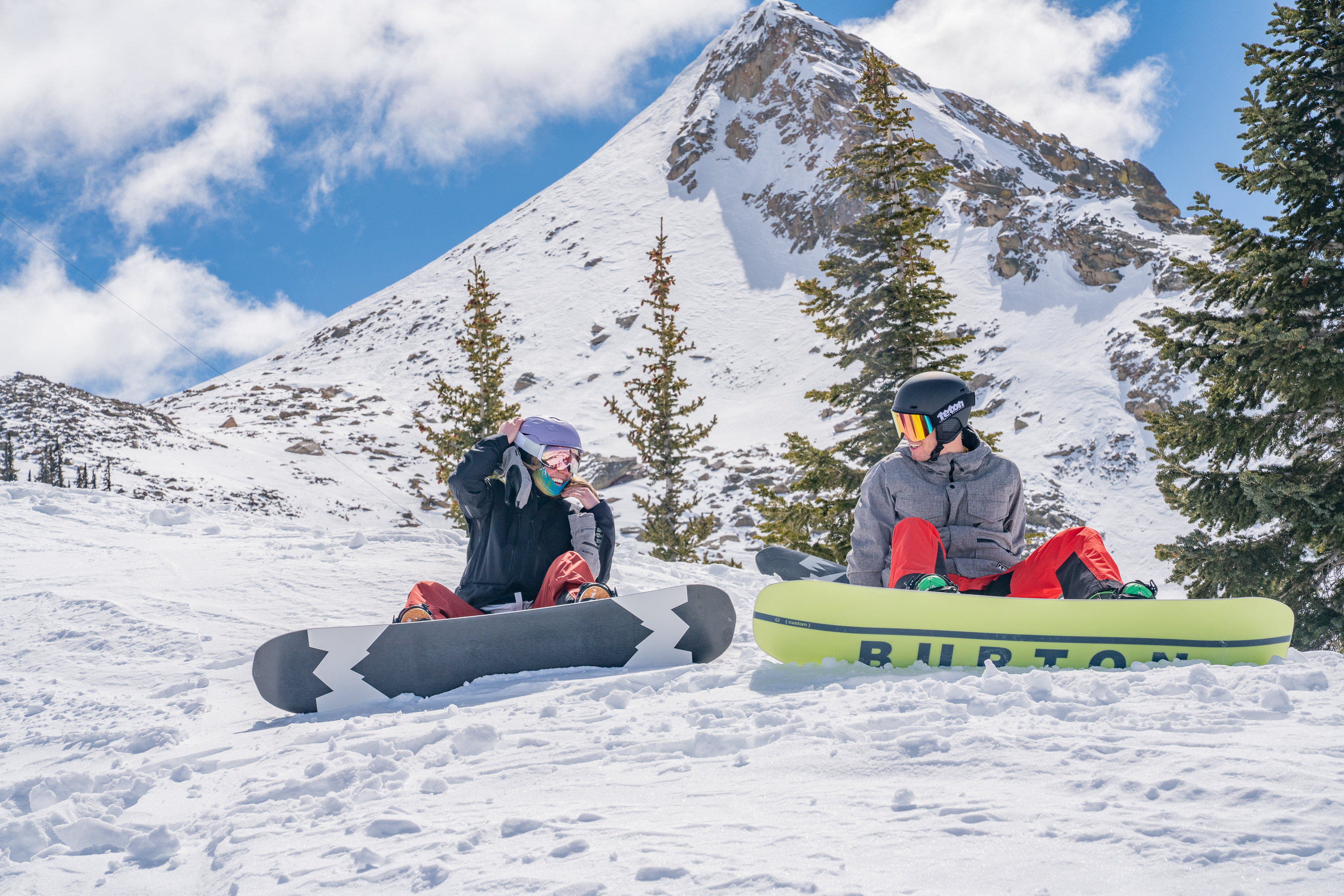 Two Snowboarders Sitting Below the Rocky Peak at Crested Butte Mountain Resort Two Snowboarders Sitting Below the Rocky Peak at Crested Butte Mountain Resort
