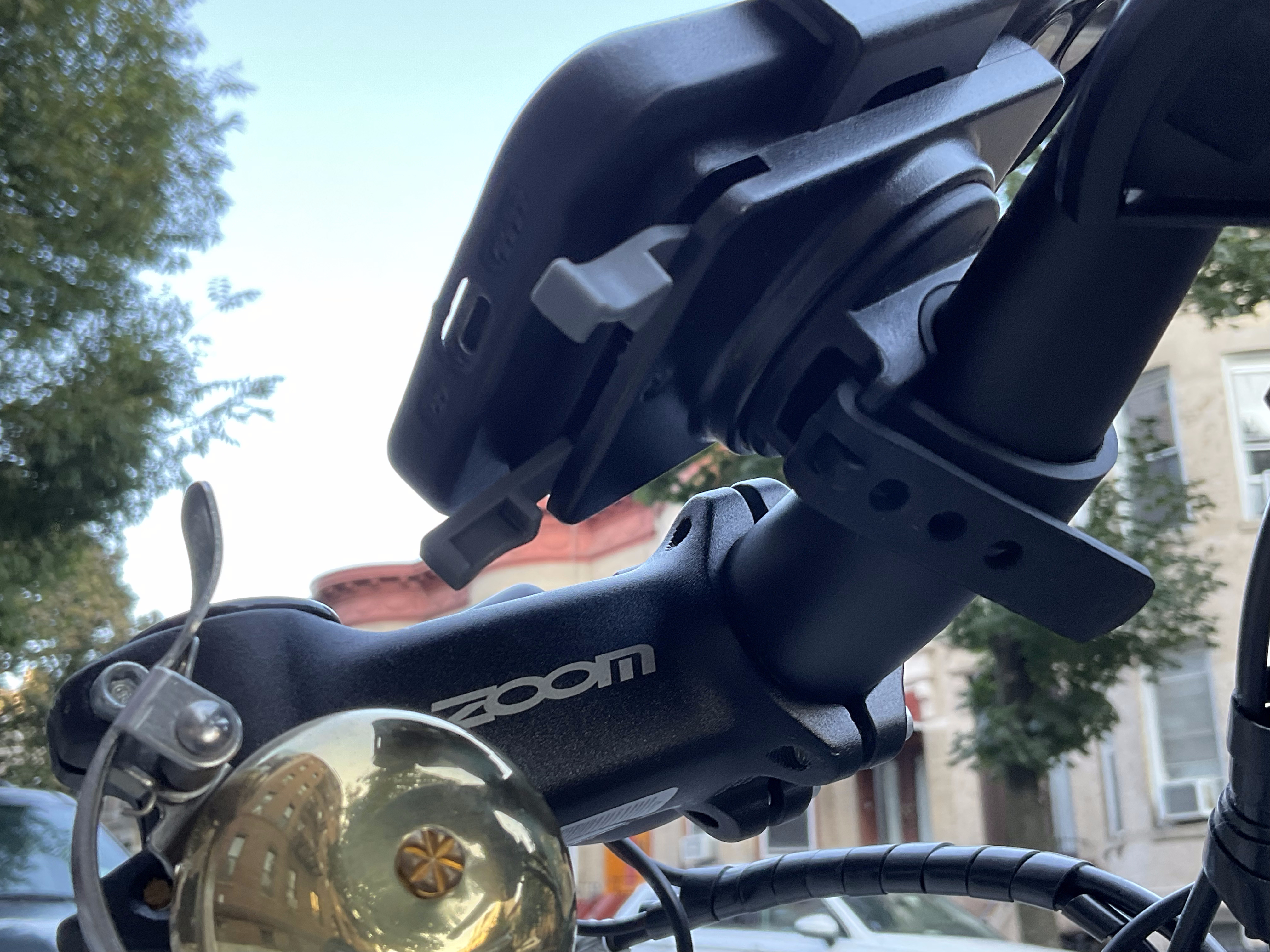 The bottom view of a Nite Ize phone mount on the handlebars of an electric bike.
