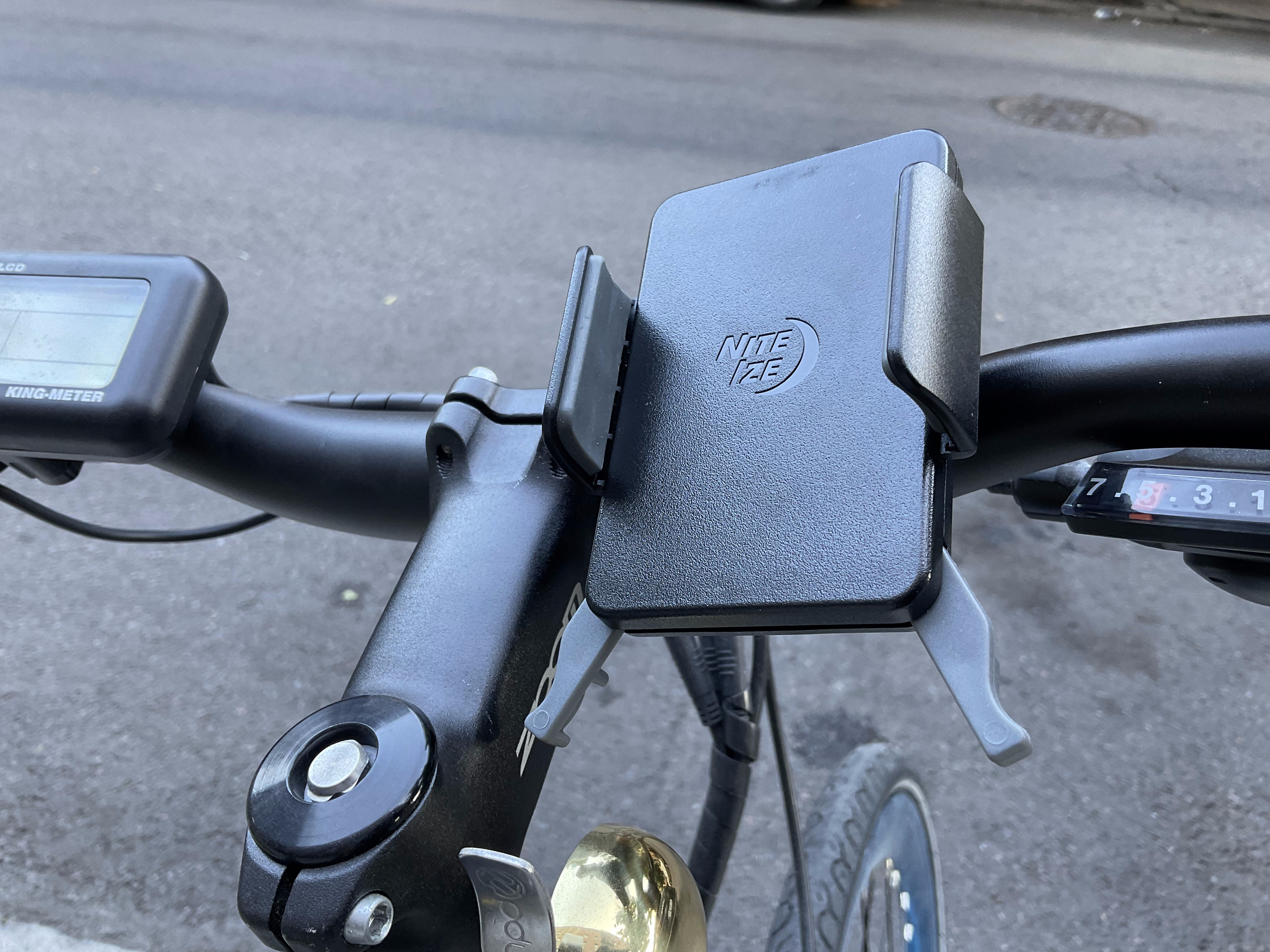 A Nite Ize phone mount on the handlebars of an electric bike.