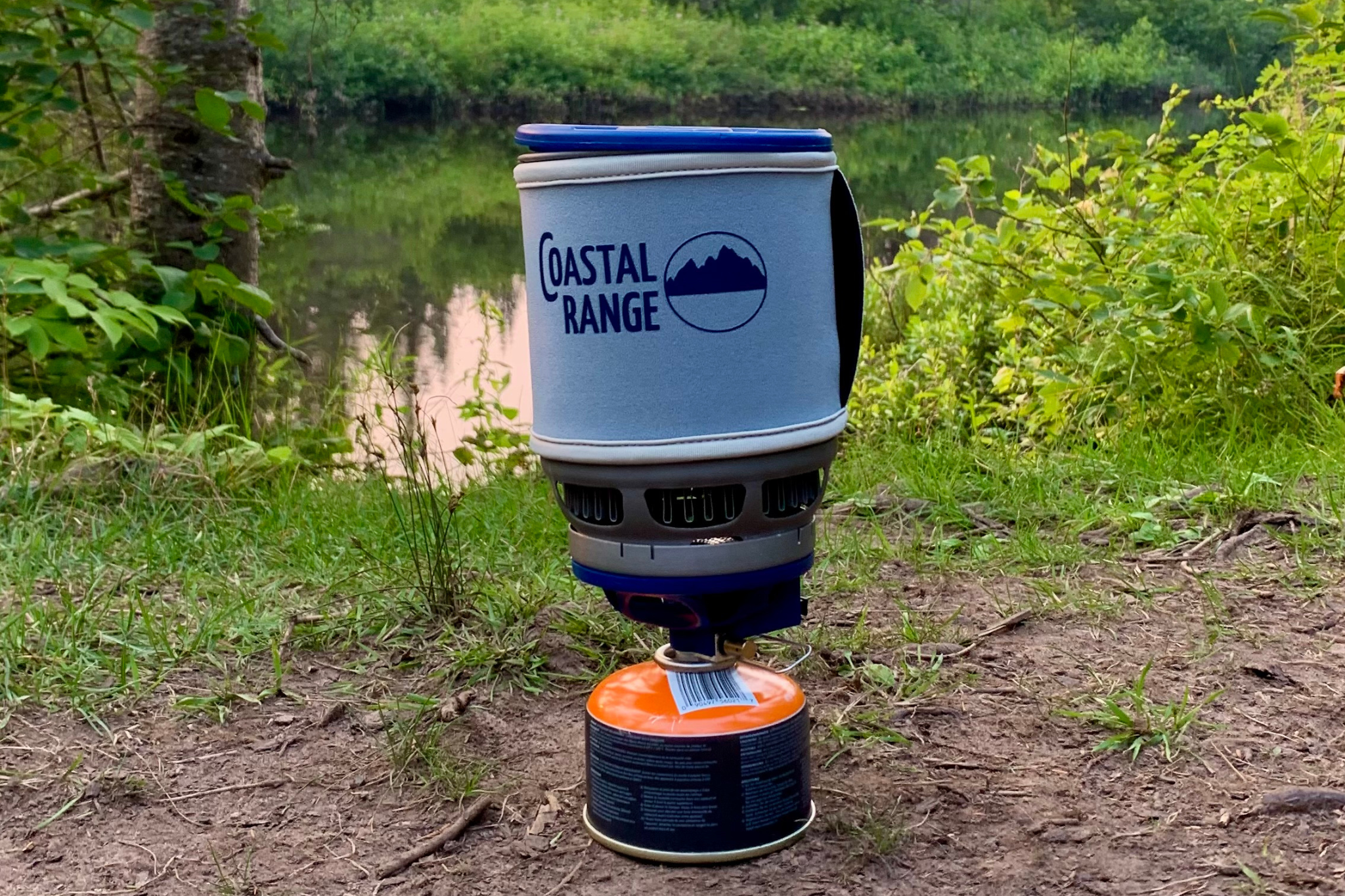Stove set up with gas canister by river