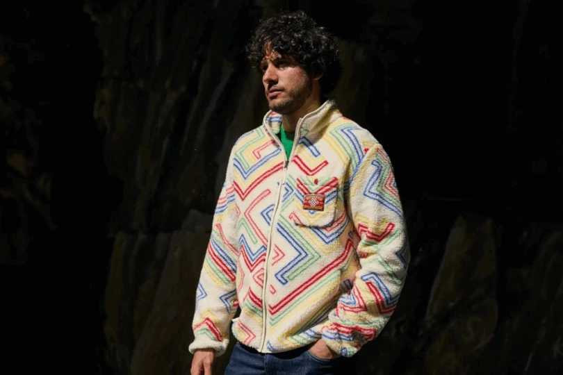 Person wearing fleece jacket with colorful zig zag pattern