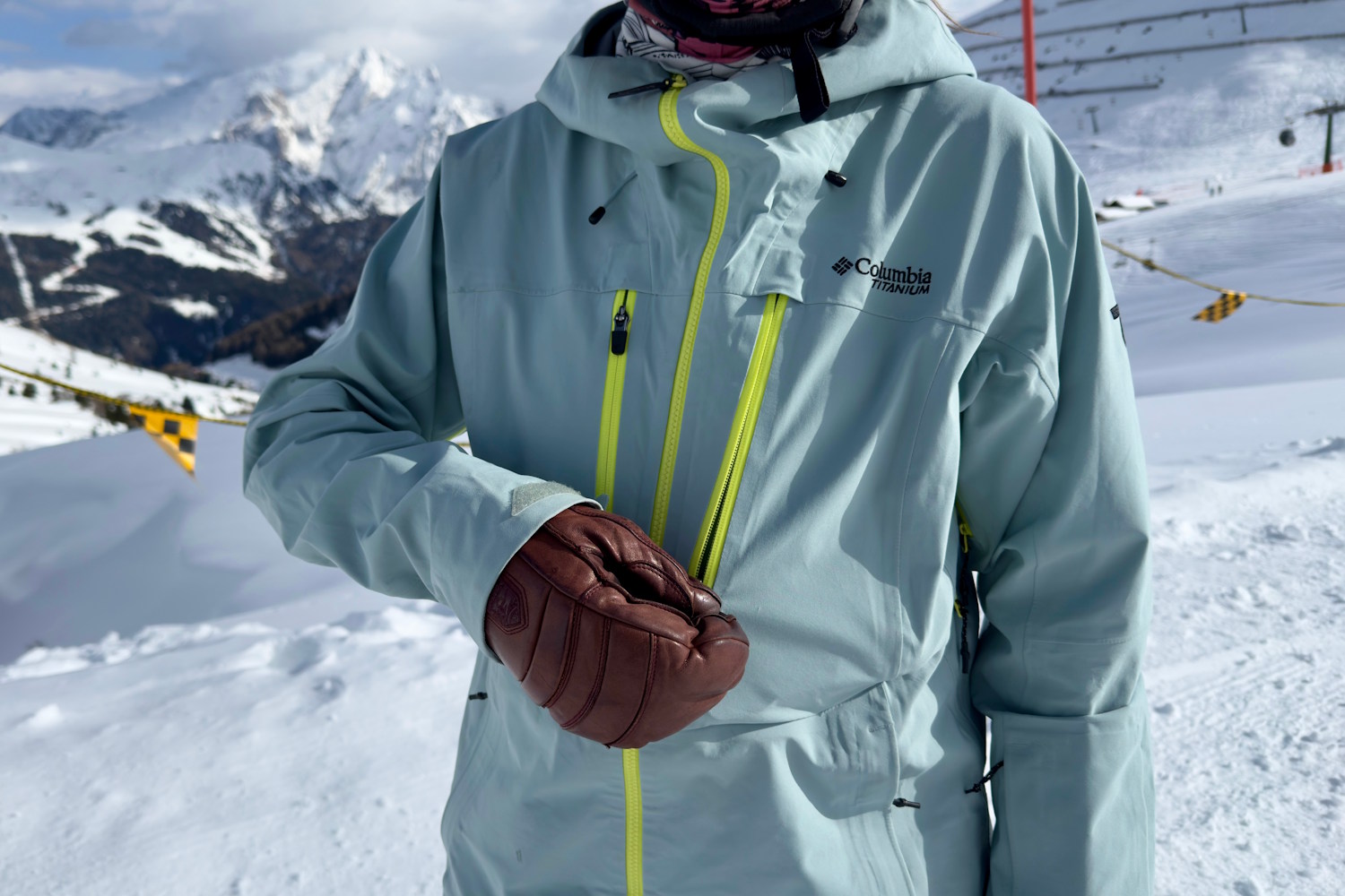 Close-up of a person wearing the Columbia Platinum Peak II jacket, zipping up the chest pocket