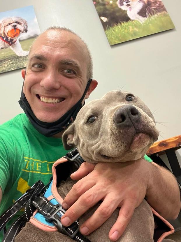 Juan Saro poses with his dog. The disabled Navy veteran says SNAP benefits are the only way to keep food on the table for his family. (Photo courtesy of Juan Saro)