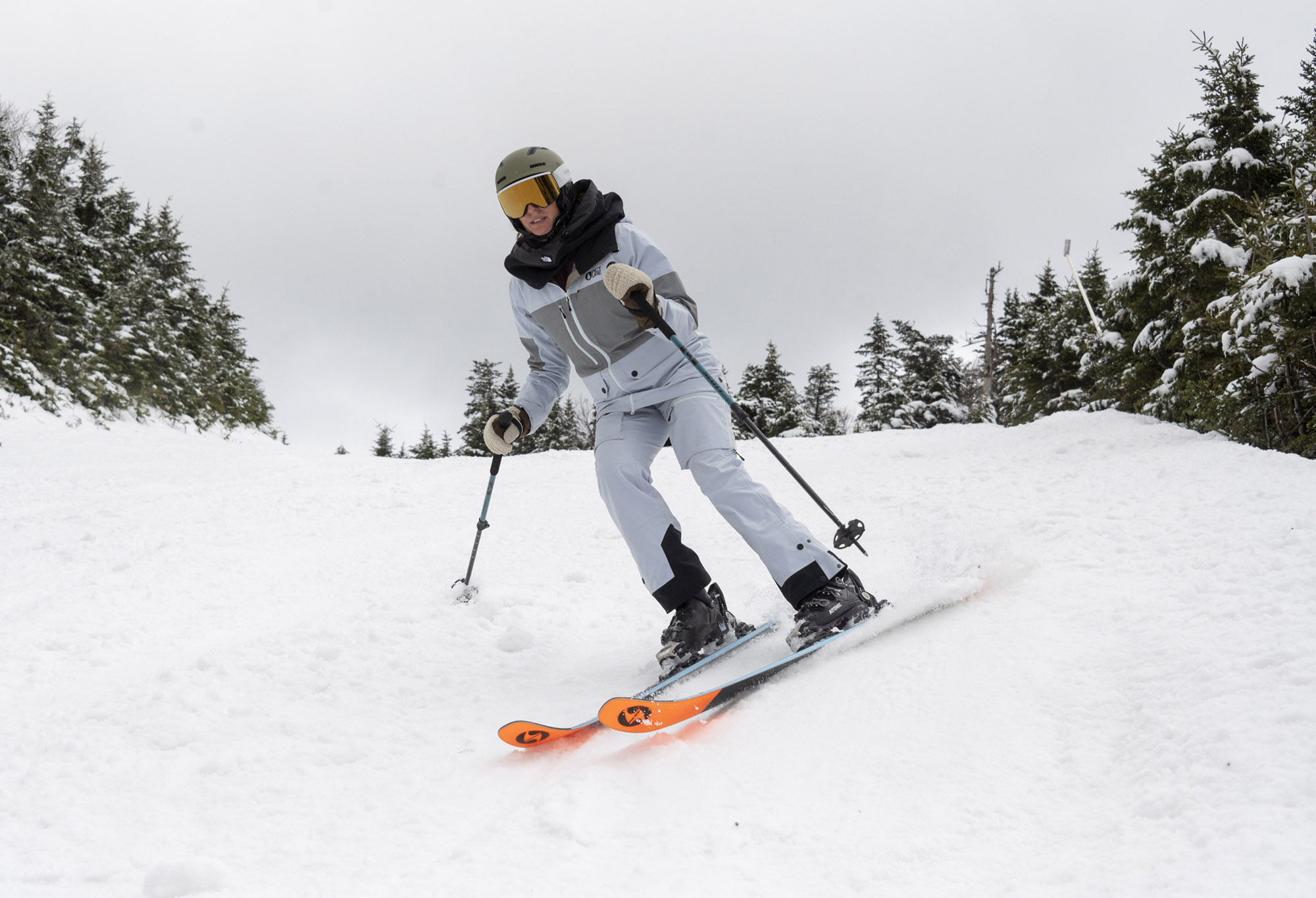 A skier carving on groomed snow with Blizzard Black Pearl 88 skis
