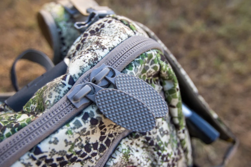 Large zipper tabs on a backpack.