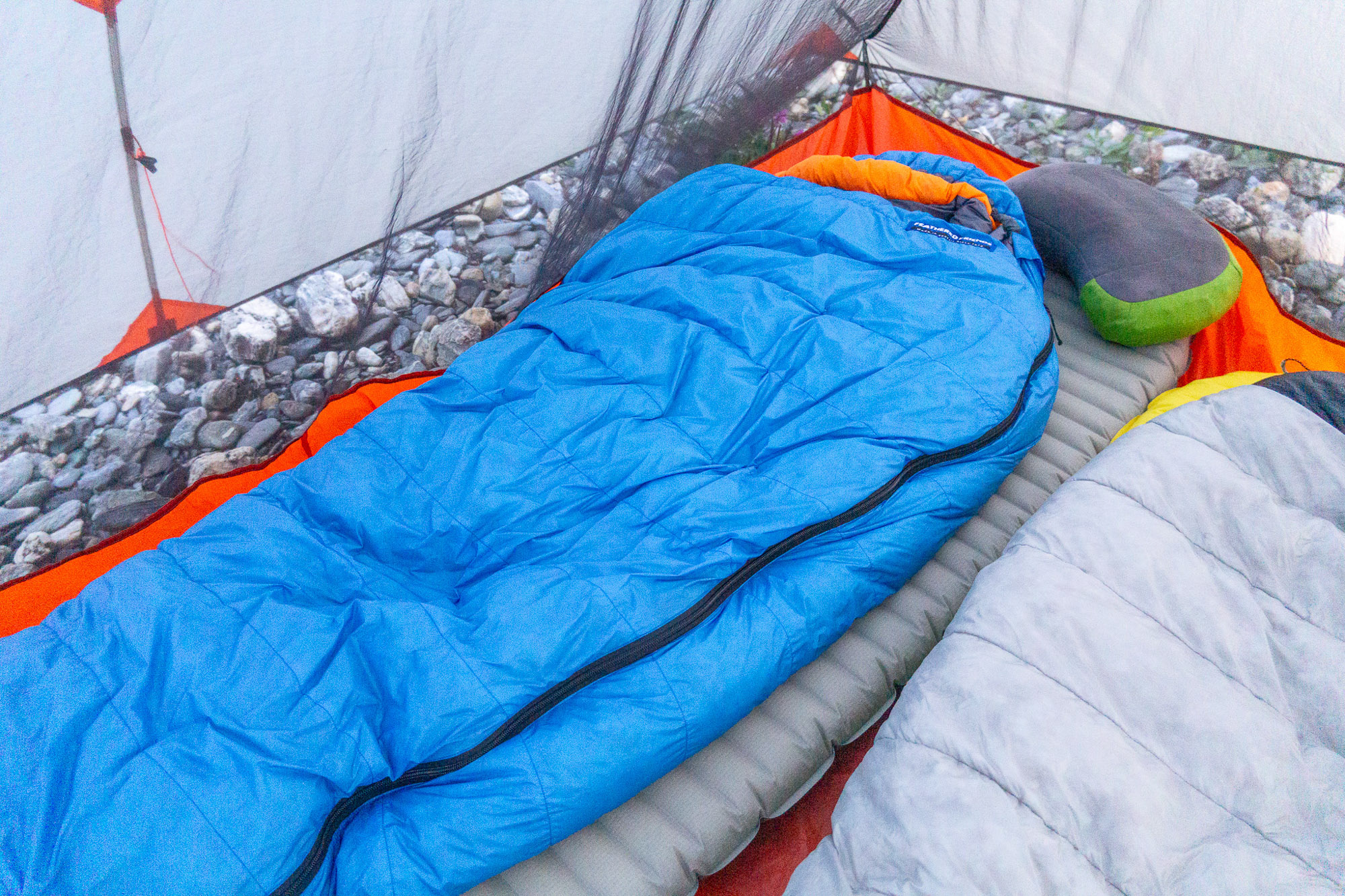 the feathered friends swallow bag in a pyramid tent in alaska beside a mountain hardwear phantom bag