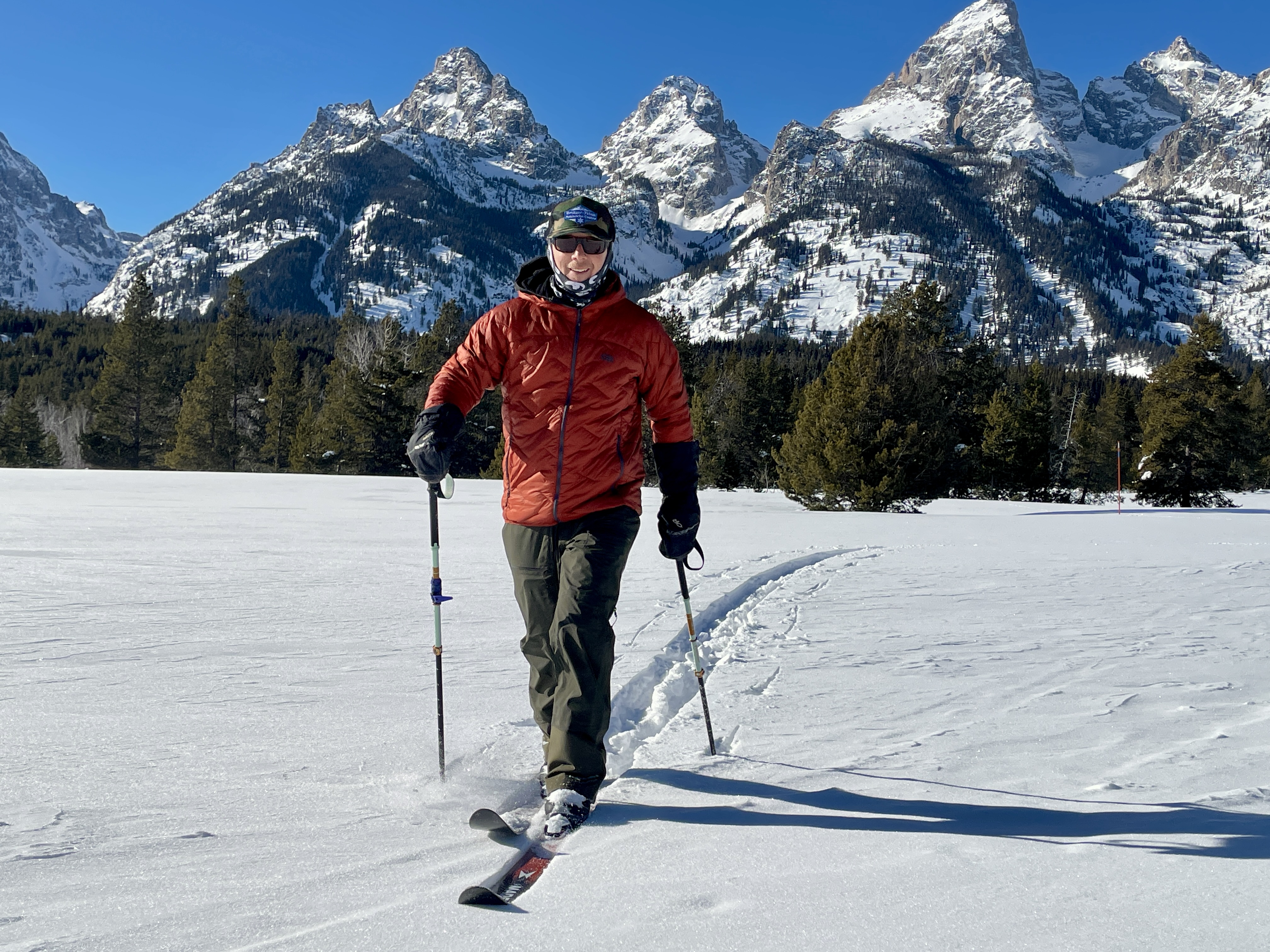 a man skiing in a red jacket