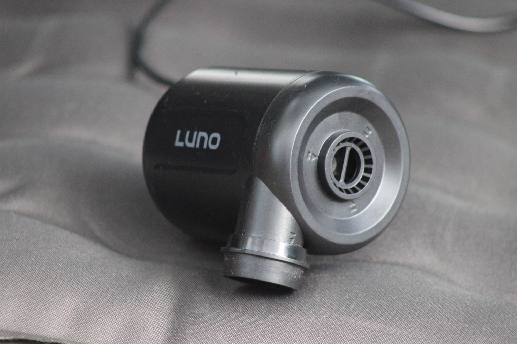 a tight image of the included luno air pump sitting on top of the mattress