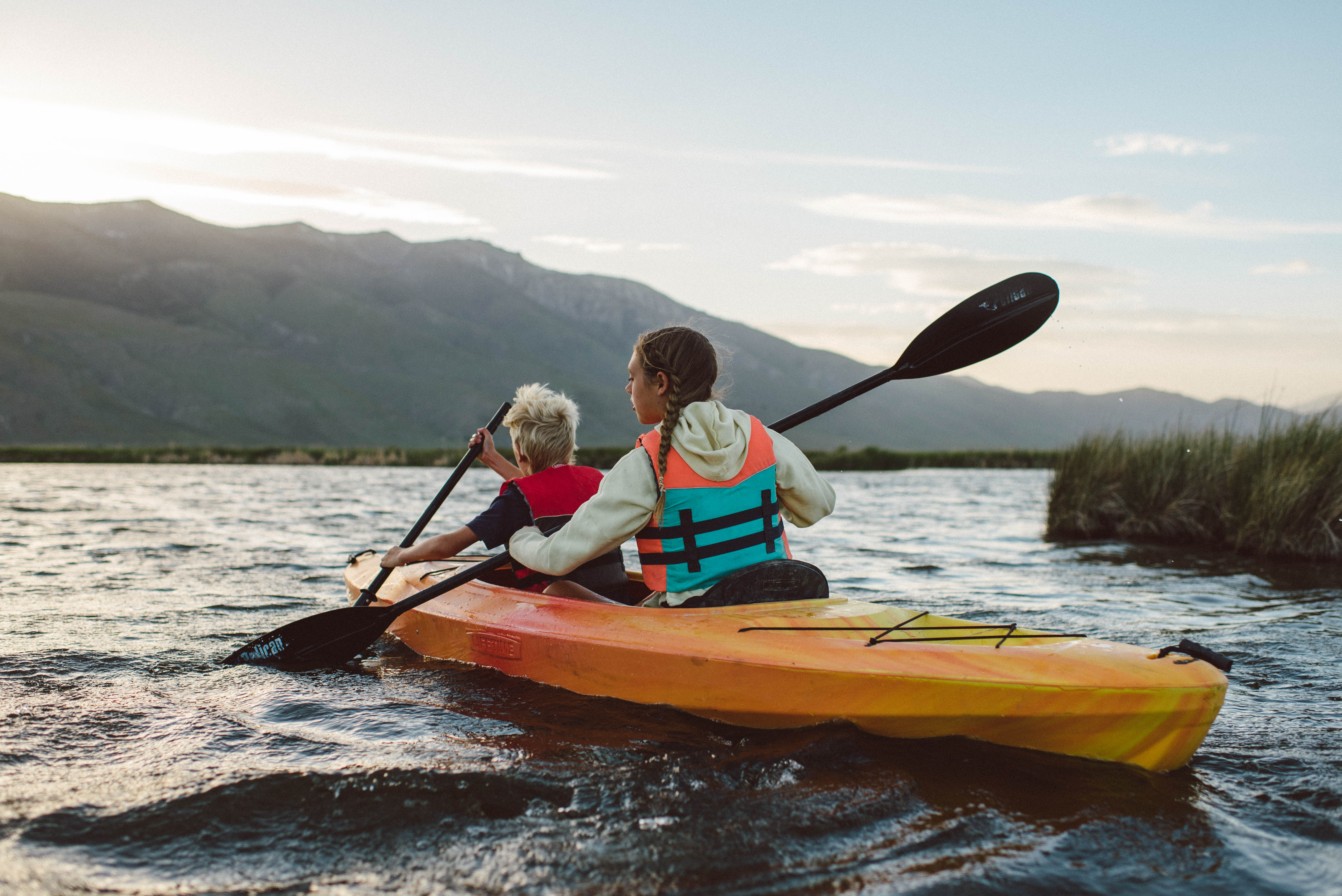 Two kids paddle a double kayak on the Ruby Lake National Wildlife Refuge
