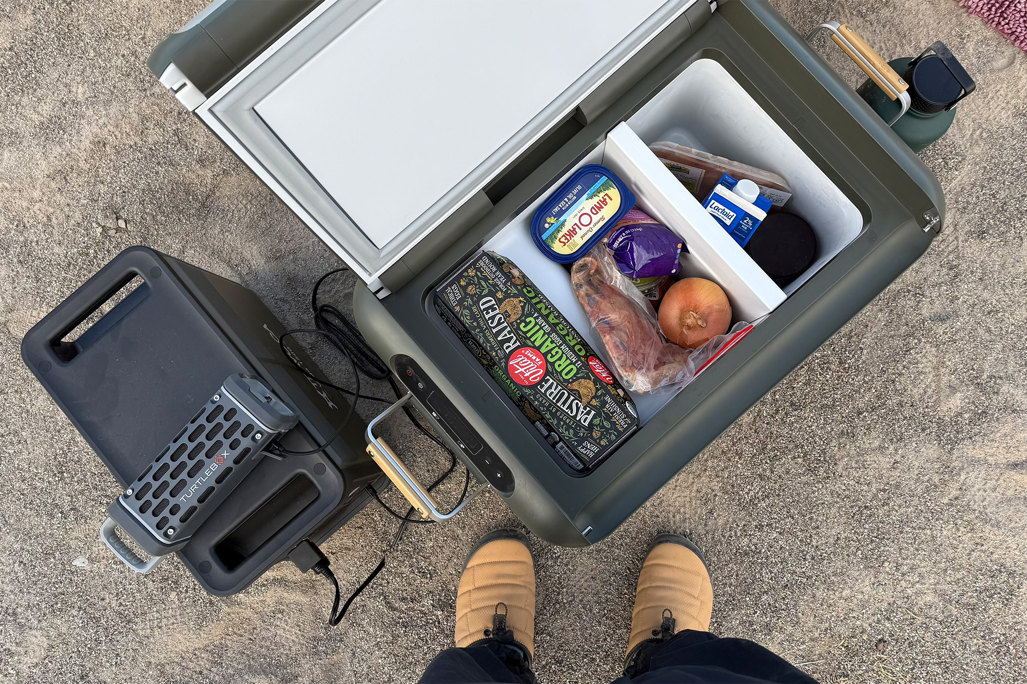 View from above showing the TRAVOCA Rigel DZ eCooler filled with food and connected to the power station