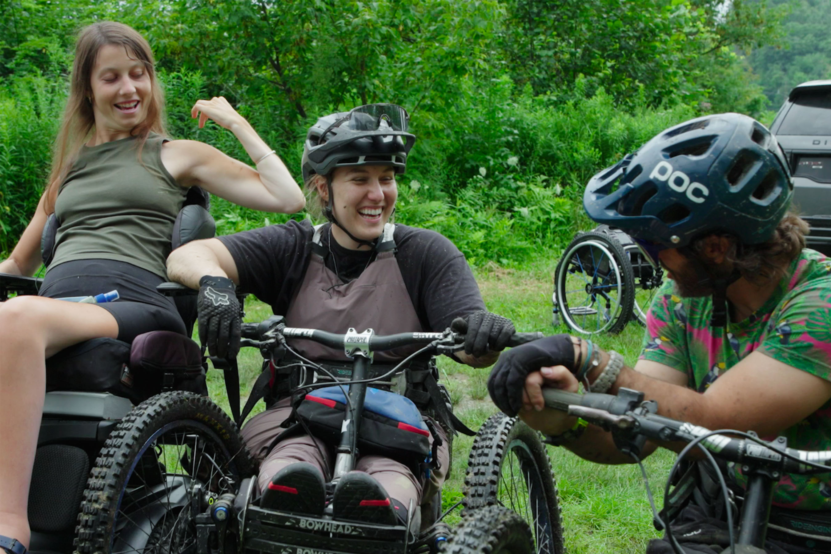 Three adaptive riders laugh together
