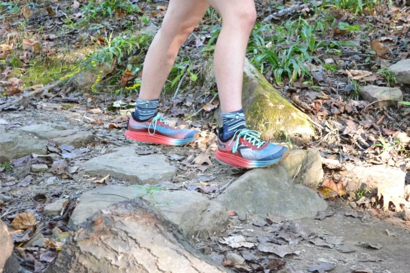 Close up of person with trail runners on trail