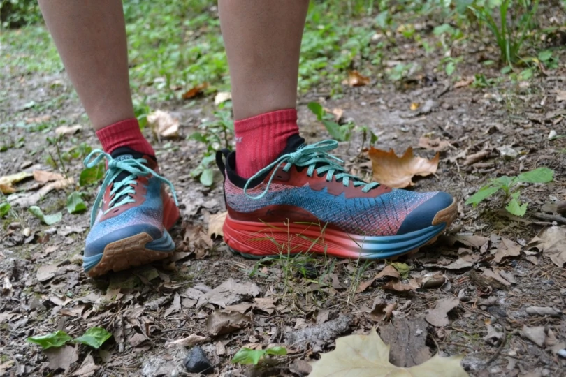 close-up shot of trail runners in forest 