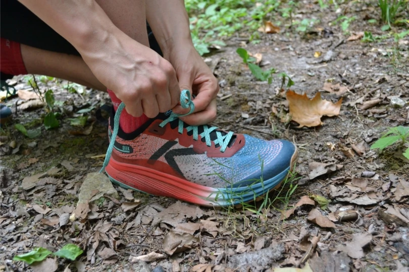Close-up shot of person lacing up shoe