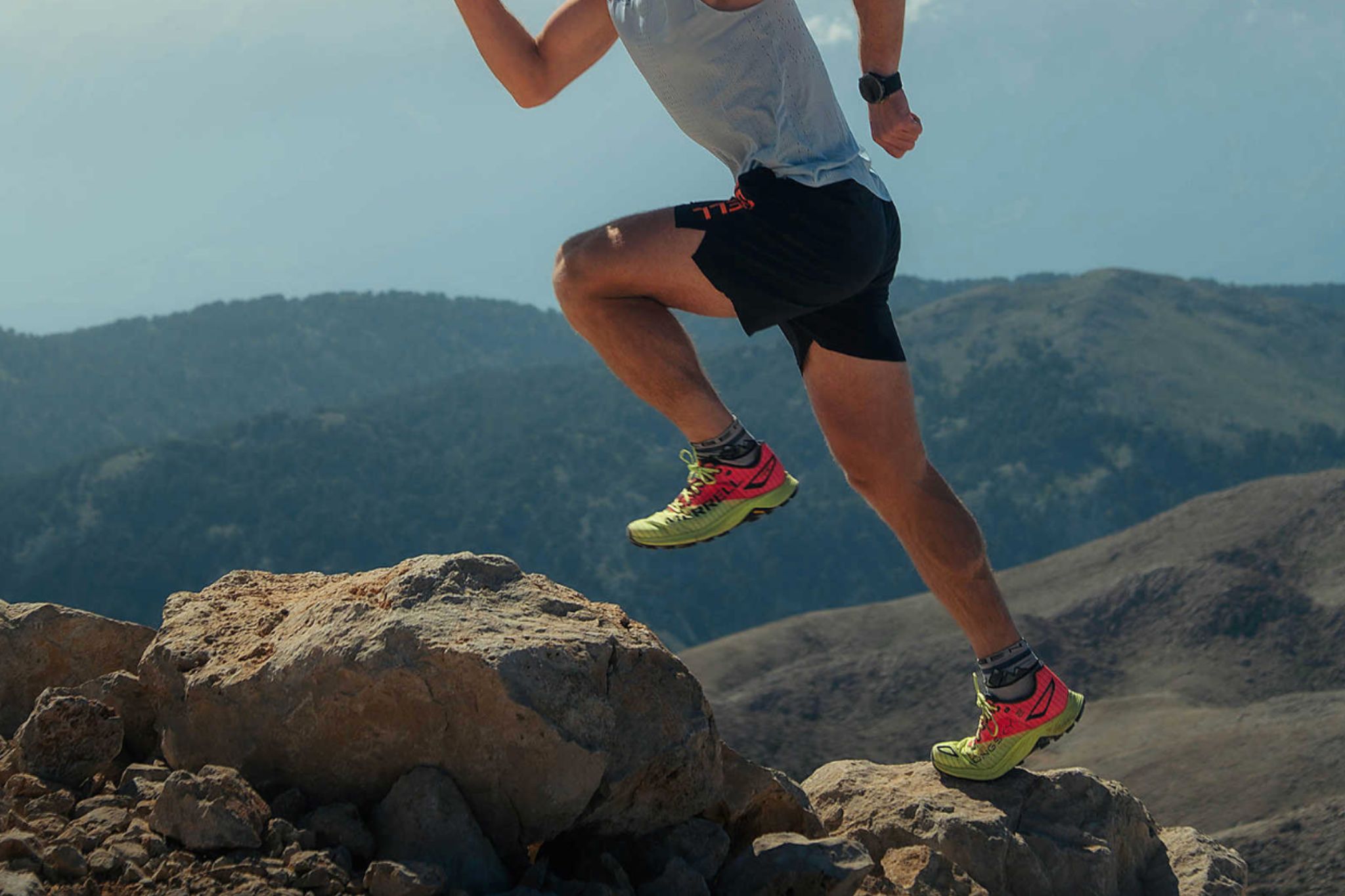 person in dynamic jumping pose while trail running