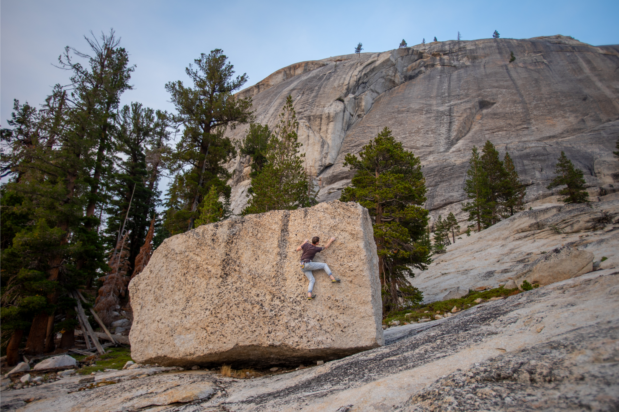 person climbing on boulder