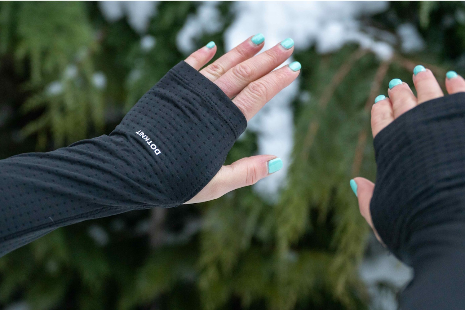 Close-up of a woman’s hands wearing The North Face Women’s FD Pro 160 Crew, showing extended sleeves with thumbholes