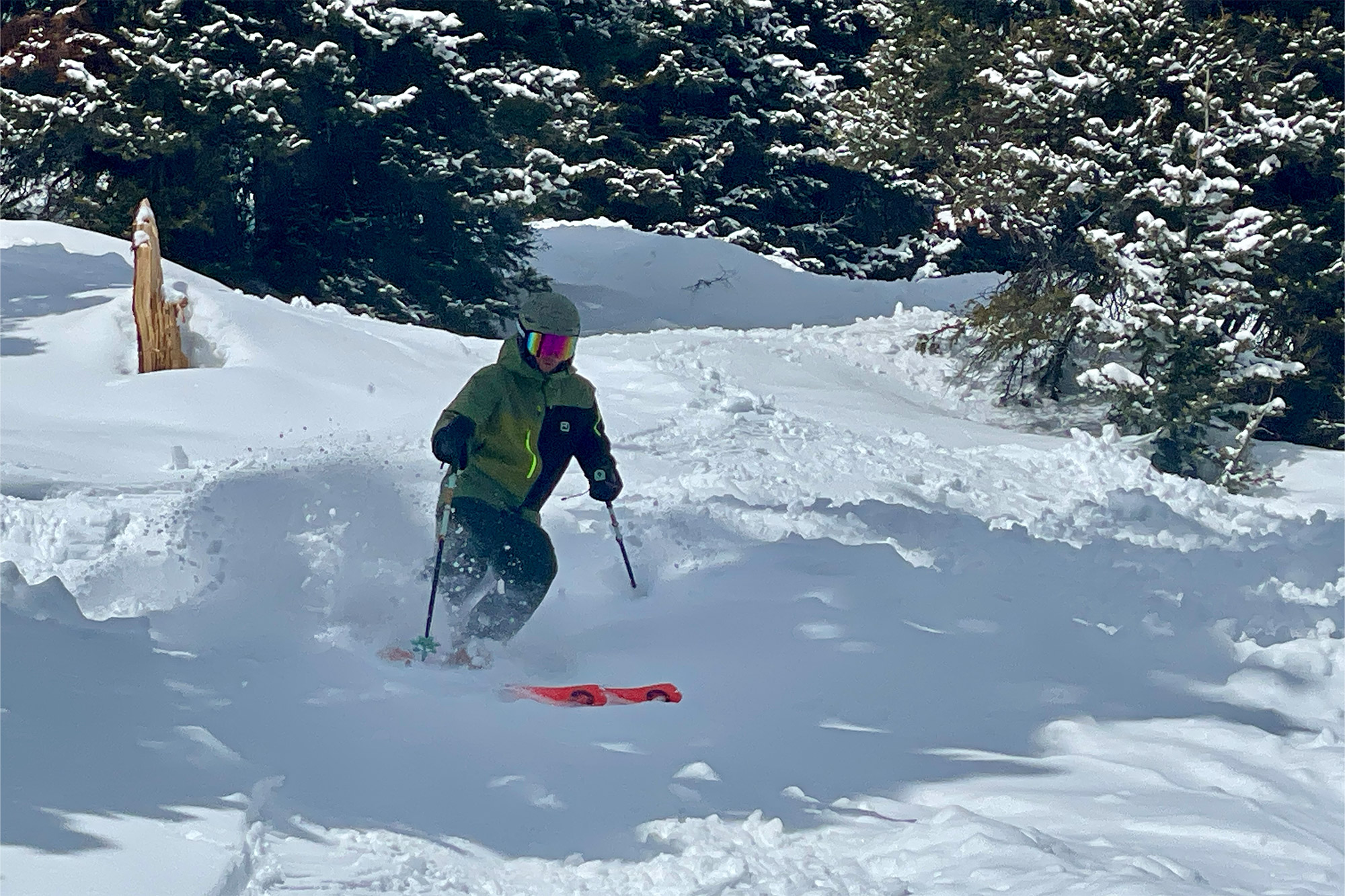 Skiing through deep powder with the Zero G 96 carving a smooth line downhill