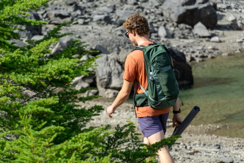 the author wearing the ibex tee as he hikes along the shore of an alpine lake in washington state