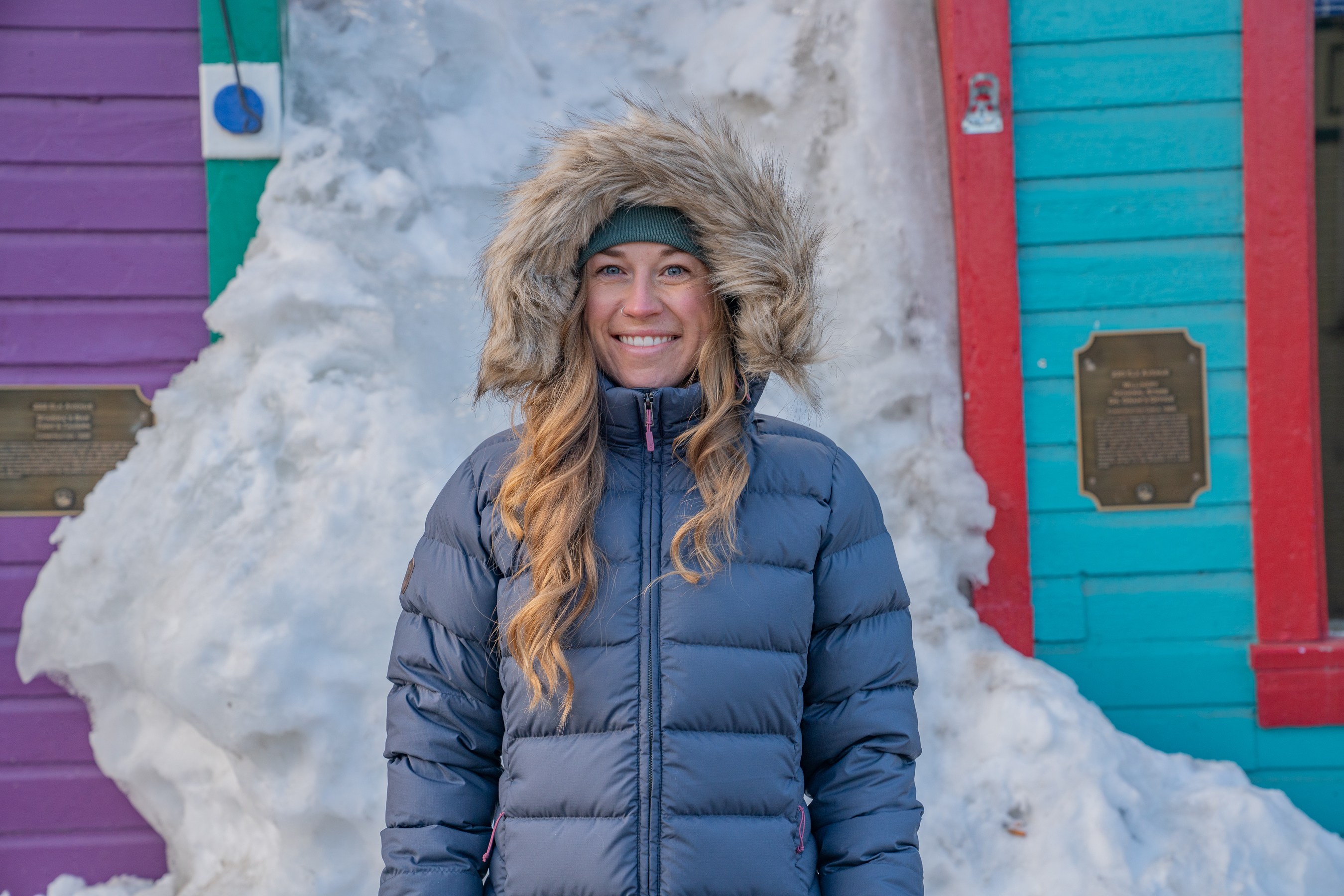 portrait of GearJunkie Snowsports Senior Editor Morgan Tilton stays warm in the hooded Rab Women’s Deep Cover Down Parka; (photo/Eric Phillips)