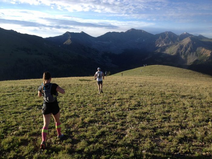 Runners in the Never Summer 100 ultramarathon on a ridge