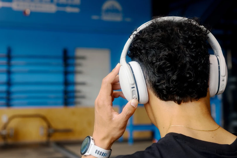 man wearing over ear headphones at gym