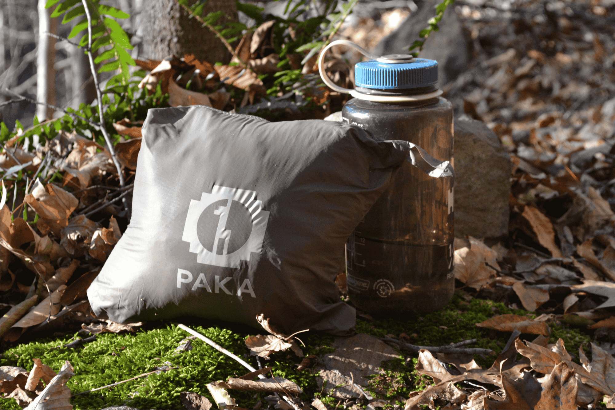 Jacket packed up in stuff sack next to Nalgene water bottle