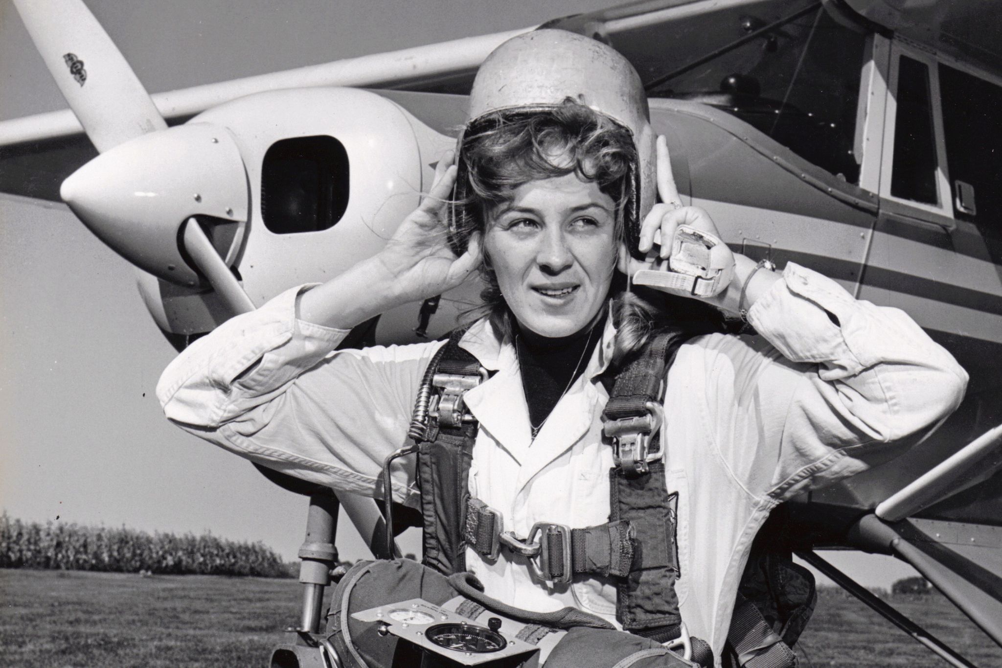 Black and white photo of a woman getting ready for skydiving