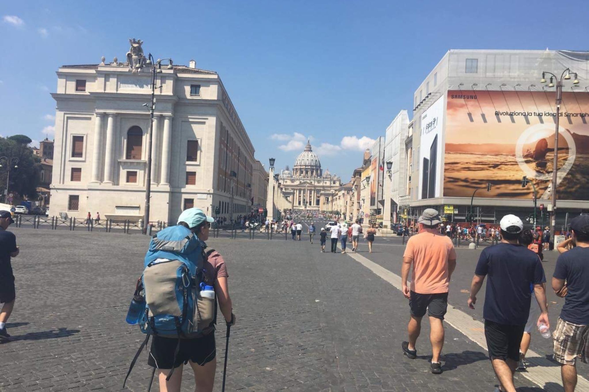 Hiker on streets of Rome toward St. Peter's