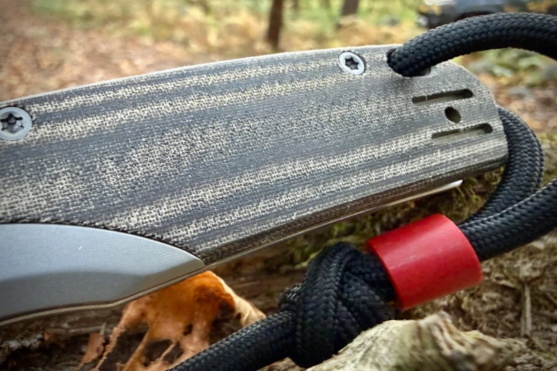 The textured Norplex handle with red bead and black cord detail