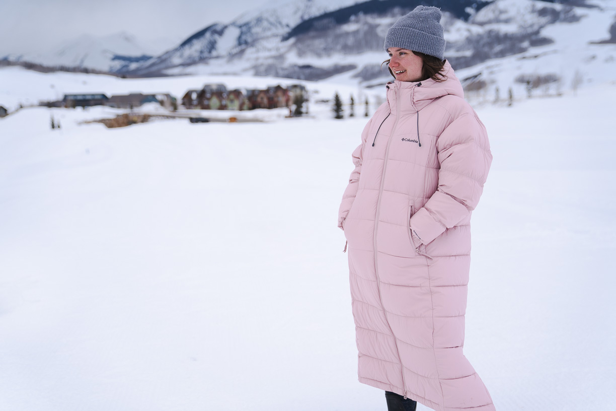woman testing the  Columbia Women's Pike Lake II Long Jacket in wintry setting