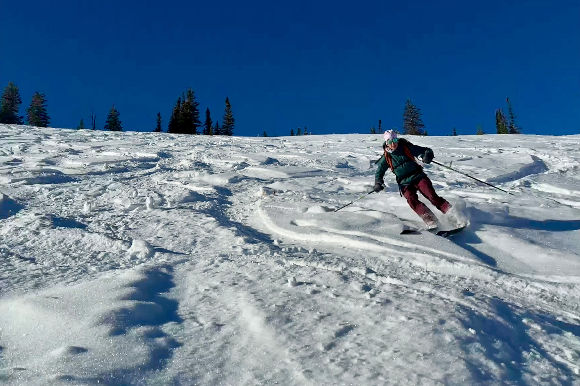 Skiing down firm snow with the touring boots driving the turns