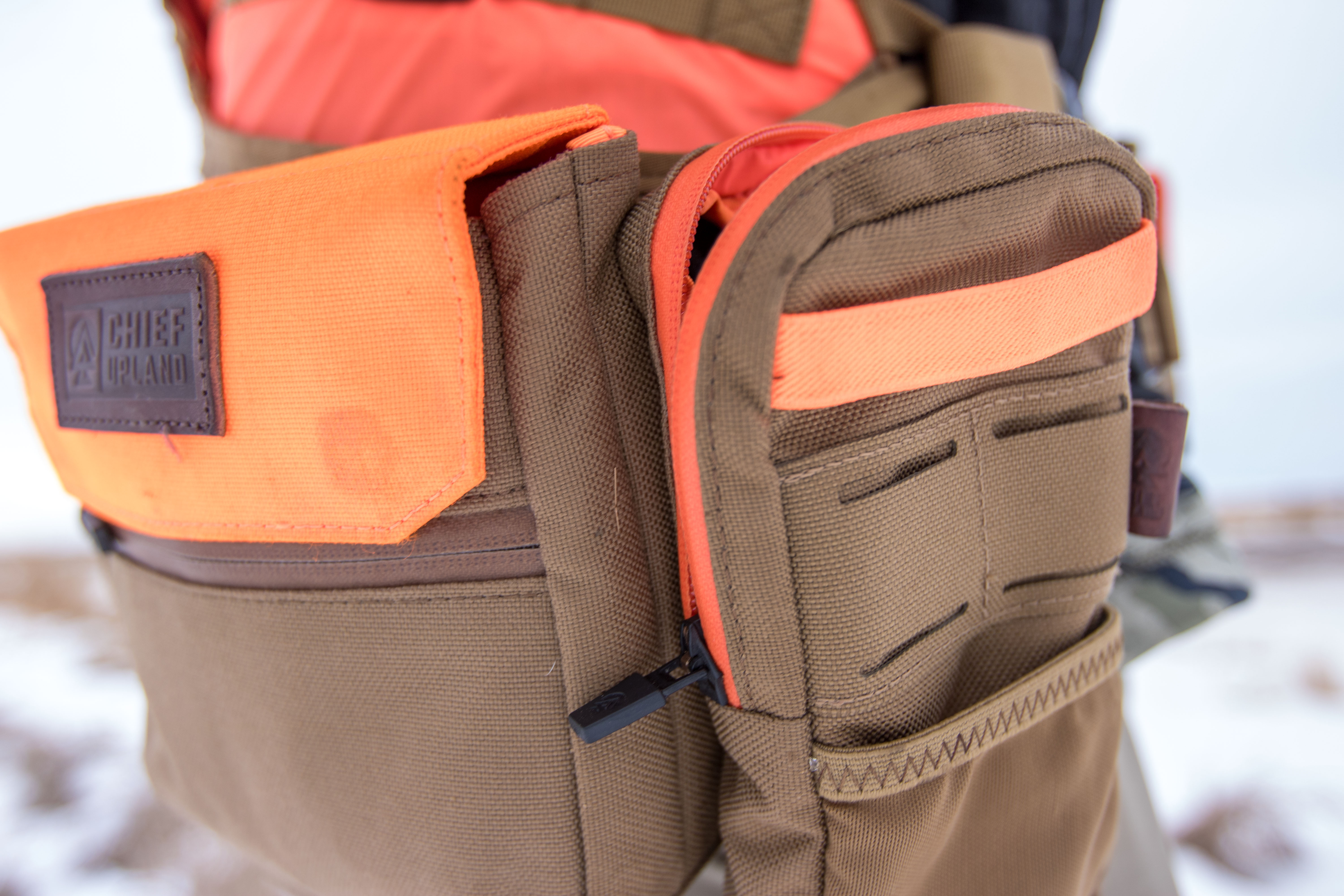 An ammo pouch and electronics pouch attached to the Chief Upland Over/Under vest.