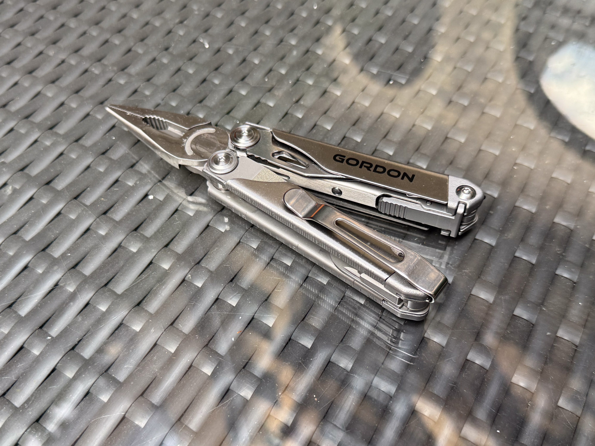 the gordon multitool with pliers extended on a table