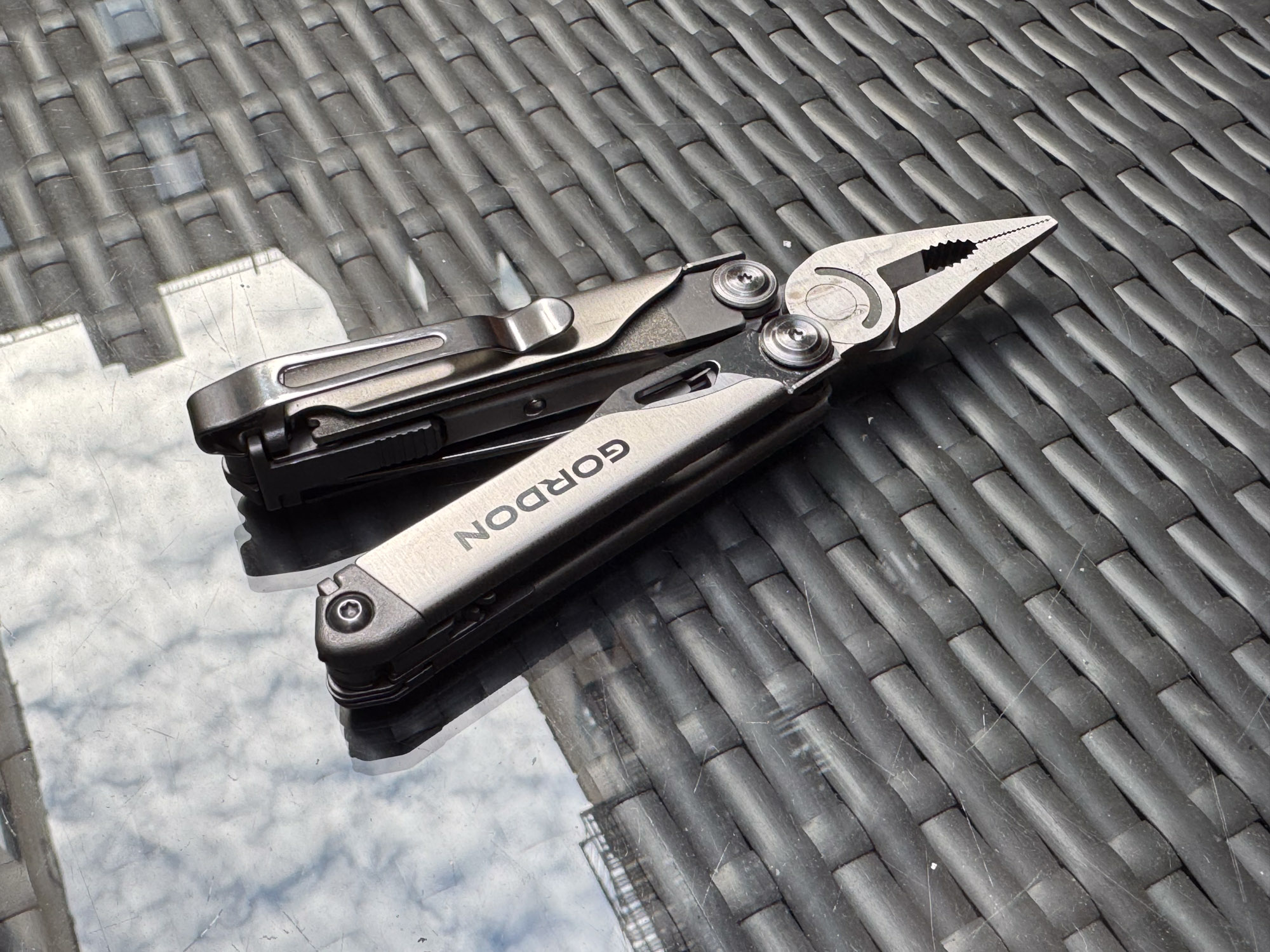 the gordon multitool on a glass-topped table outdoors