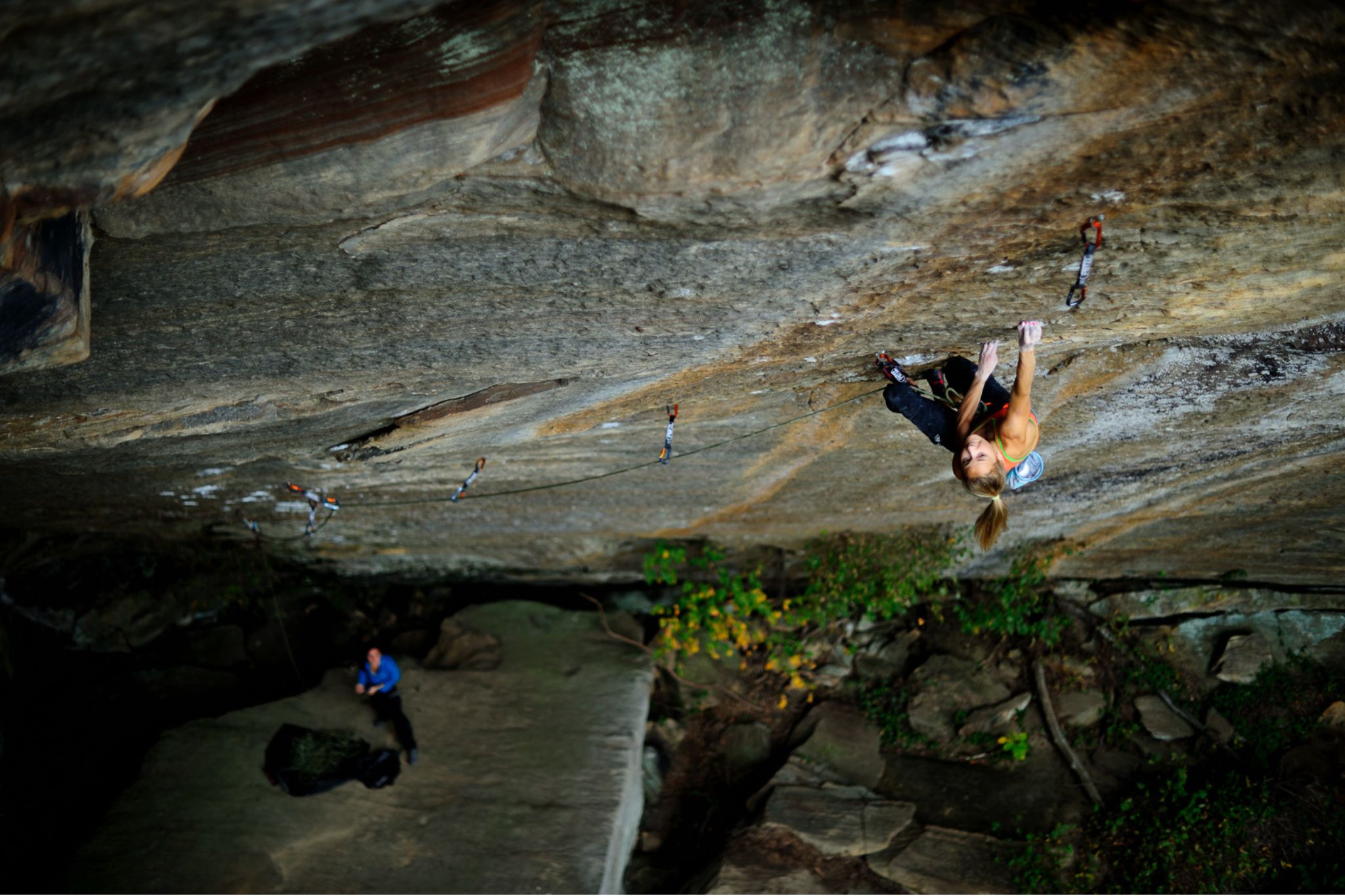 Person climbing up steep wall