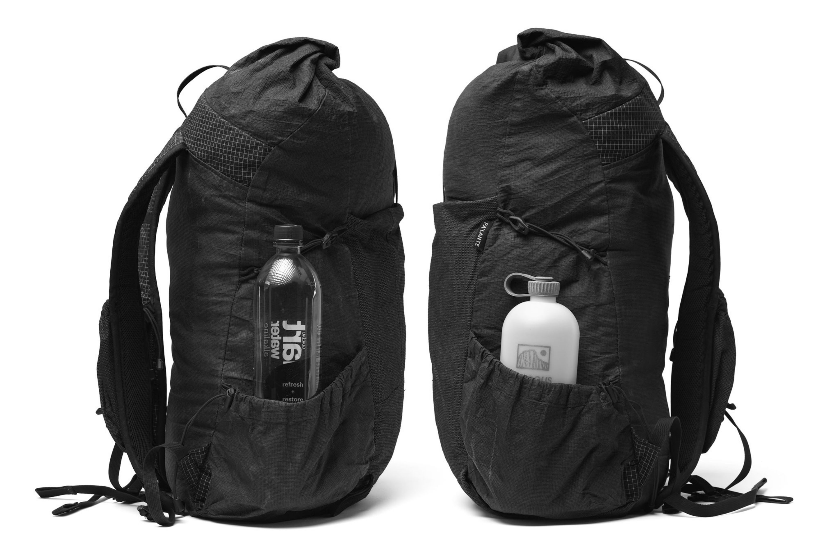 Two black backpacks side by side with different water bottles