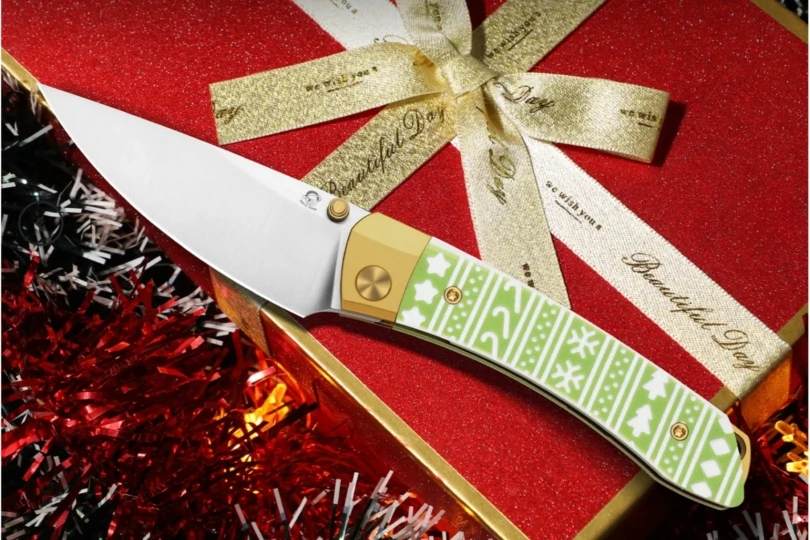 holiday themed knife on red present