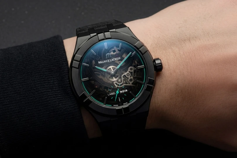 Close-up shot of black and turquoise watch on wrist