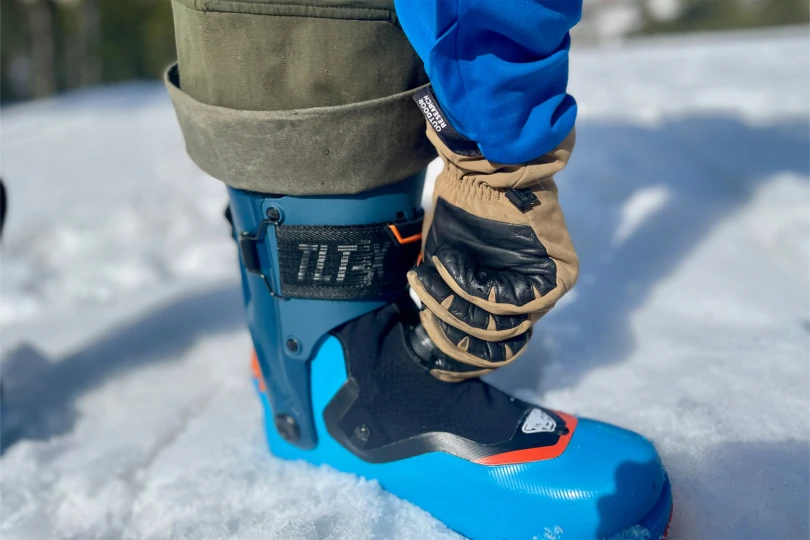 A close look at tightening the boot dial while standing on packed snow