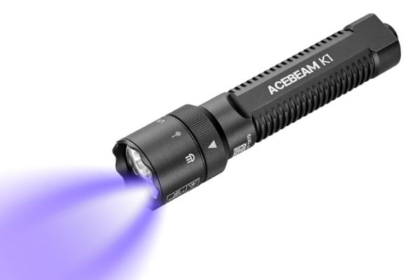 The Acebeam K1 flashlight with the UV light on.