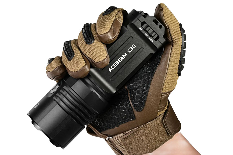 The Acebeam X30 flashlight in a gloved hand.