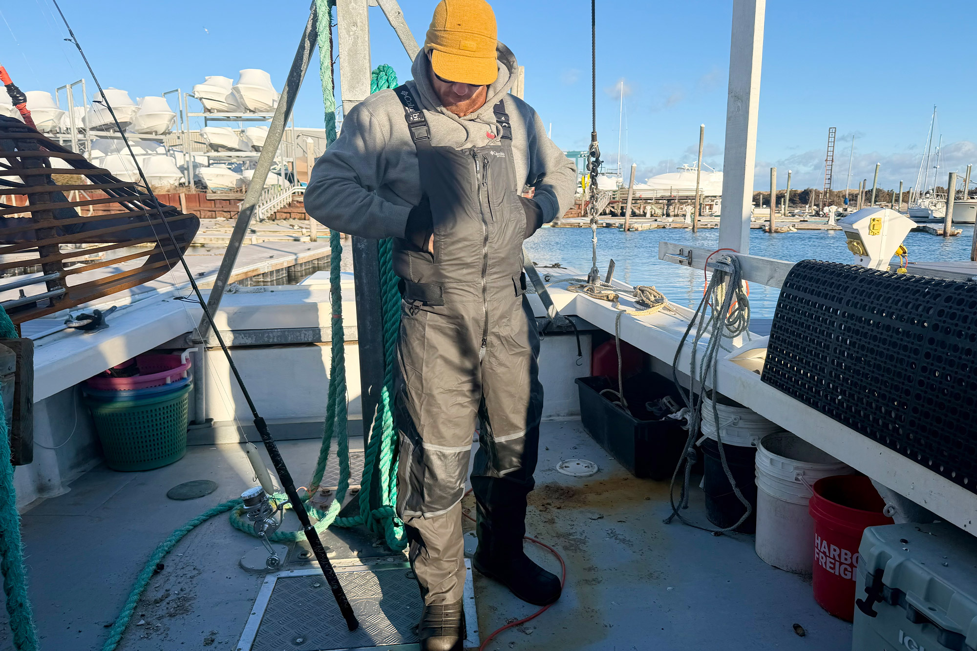 The Columbia PFG Force XII ODX Bib worn while moving and working on a fishing boat deck