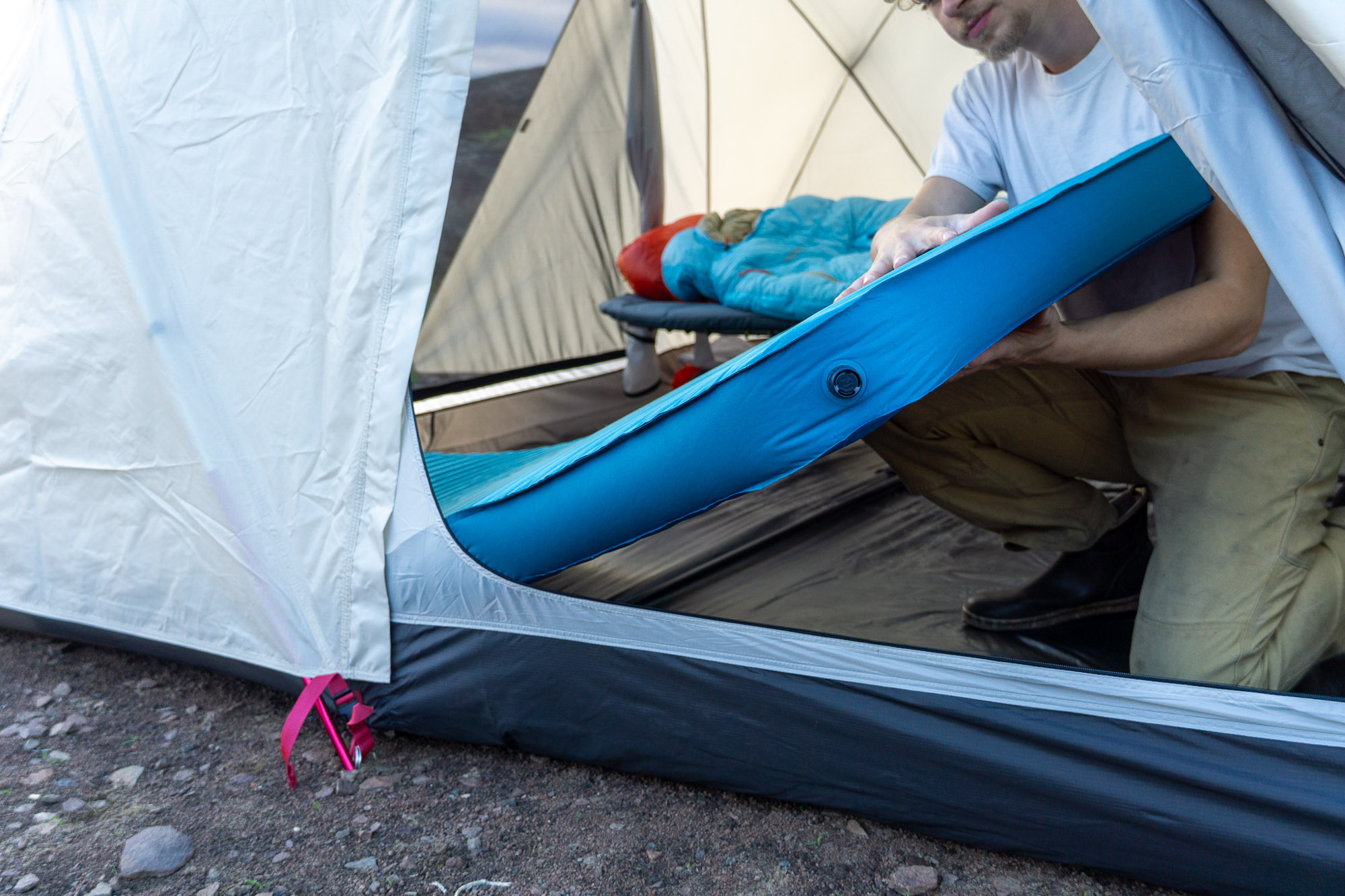 the author holds the mondoking mattress up and displays the 4" thickness