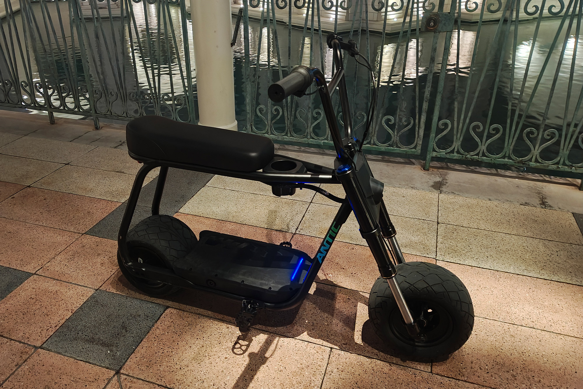A side view of the Future Motion Antic eBike standing on a tiled walkway