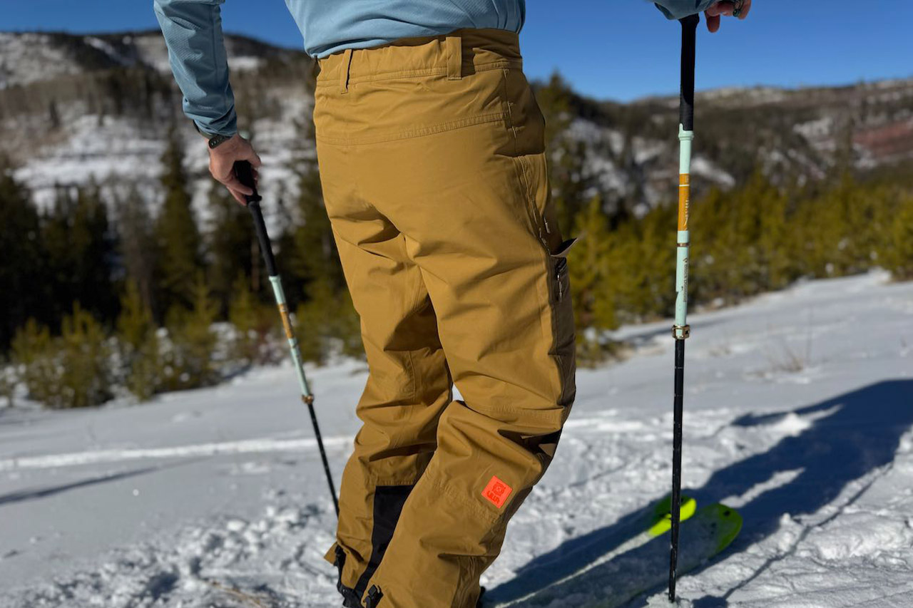 Rear view of Helly Hansen Emiko Shell Pants showing seat and back leg coverage on snow