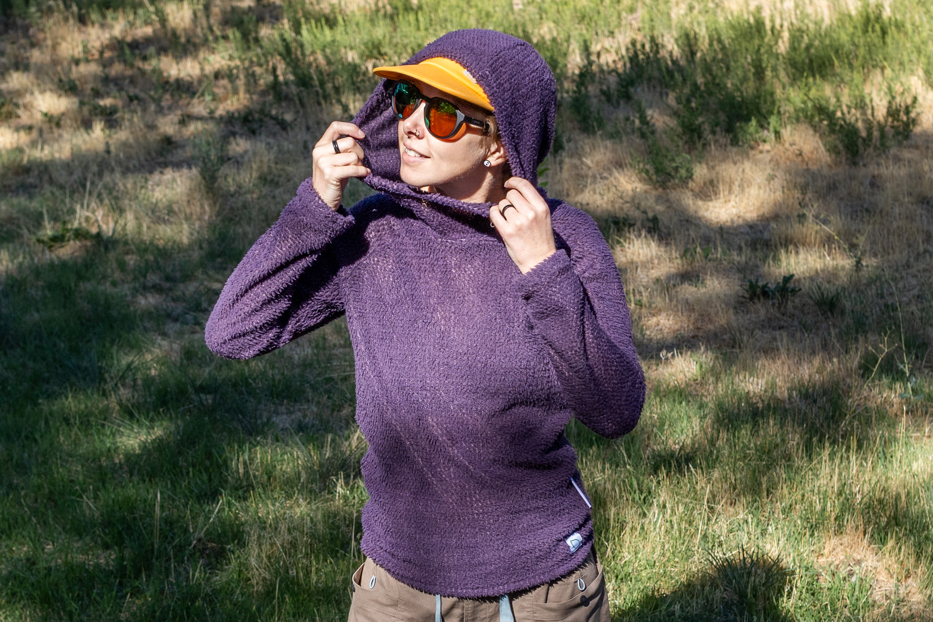 Polartec Alpha Direct LEVE Outdoors Hoody worn by a person outdoors, with the hood pulled up